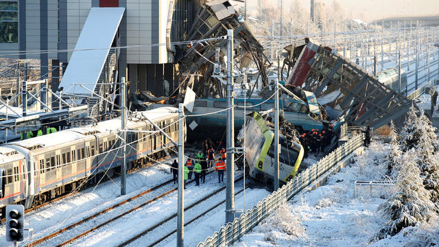 Rescue workers search at the wreckage after a high speed train crash in Ankara 