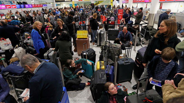 Passengers wait around in the South Terminal building at Gatwick Airport after drones flying illegally over the airfield forced the closure of the airport, in Gatwick 