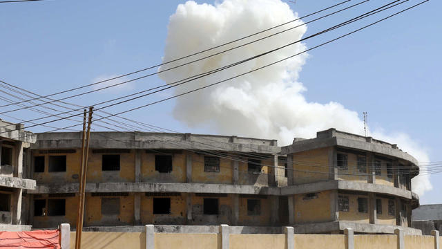 Somali security officers take position after a second explosion in Mogadishu 