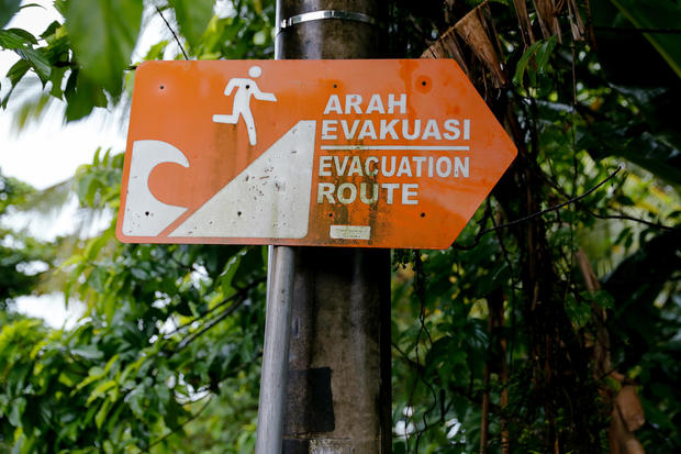 A sign directing to a tsunami evacuation route is seen after a tsunami hit an area near Carita in Pandeglang 