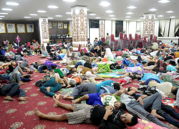 Residents, who lived at coast of Bandar Lampung, rest at government building after they evacuated following a tsunami hit Sunda strait in Lampung 