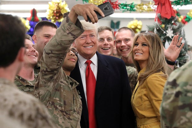 U.S. President Trump and the First Lady greet military personnel at the dining facility during an unannounced visit to Al Asad Air Base, Iraq