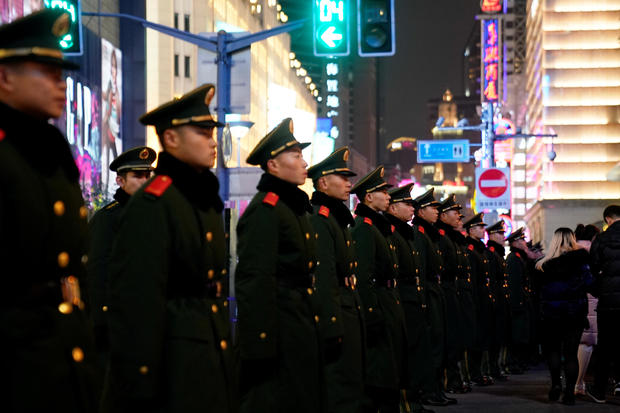 Paramilitary police stand guard near the Bund on New Year's Eve, in Shanghai 