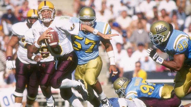 Quarterback Jake Plummer of the Denver Broncos eludes defensive end News  Photo - Getty Images