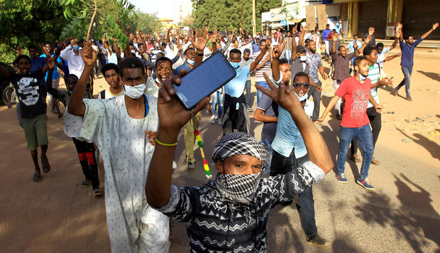 FILE PHOTO: Sudanese demonstrators chant slogans as they march along the street during anti-government protests in Khartoum 