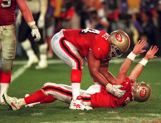 San Francisco 49ers quarterback Steve Young (on gr