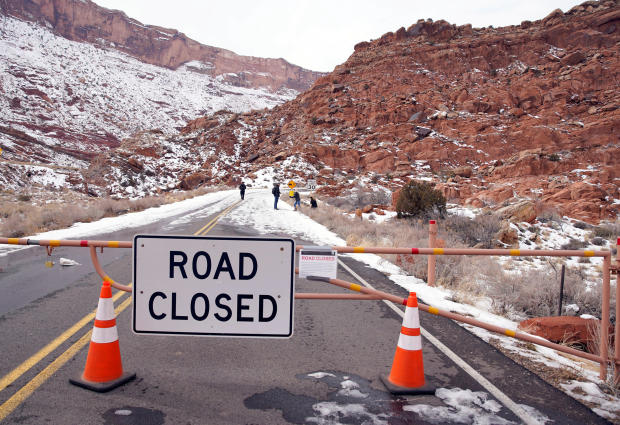 Hikers walk up the main road, which is closed because of the partial government shutdown, in Arches National Park, Utah 