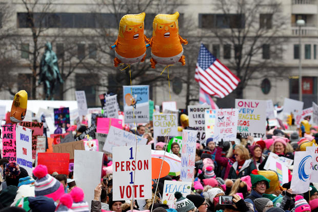 Baby Trump balloons float over thousands of people as they participate in the Third Annual Women's March at Freedom Plaza in Washington 