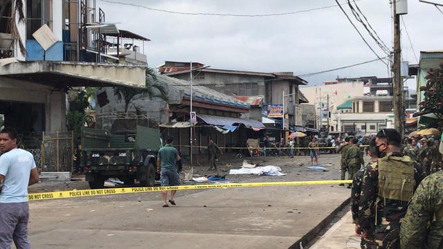 Philippine Army members secure area outside a church after bombing attack in Jolo 