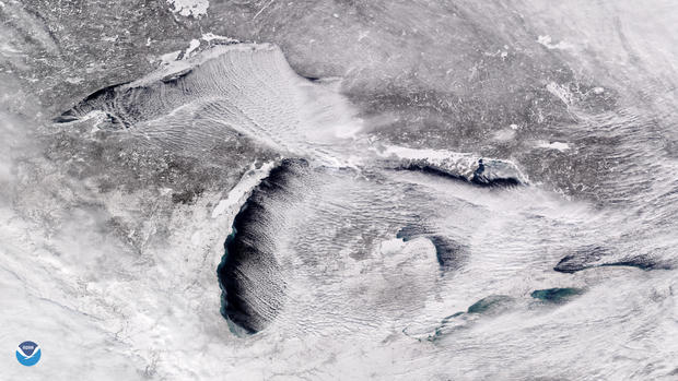 Handout photo of a satellite image taken over the Great Lakes showing rows of cumulus clouds also known as "cloud streets" streaming over the lakes' surface, caused by the frigid weather 