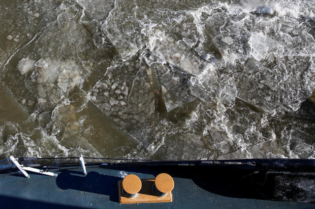 Ice is seen along the Hudson river between the towns of Kingston and Poughkeepsie while U.S. Coast Guard members work on a boat used as an ice breaker during a polar vortex in New York 