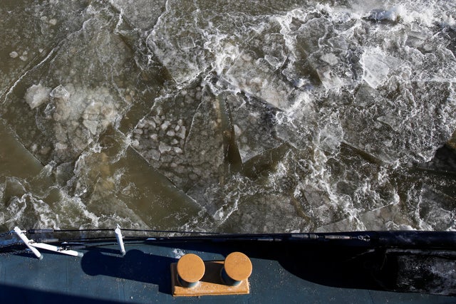 Ice is seen along the Hudson river between the towns of Kingston and Poughkeepsie while U.S. Coast Guard members work on a boat used as an ice breaker during a polar vortex in New York