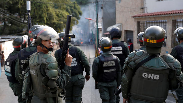 FILE PHOTO: Venezuelan National Guards are seen as demonstrators protest close to one of their outposts in Caracas 