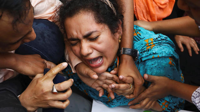 One of the relatives of victims of a fire incident mourns outside Dhaka Medical College Hospital in Dhaka, Bangladesh 