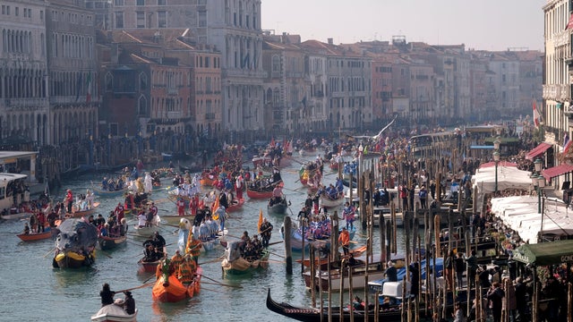 People watch a water parade marking the beginning of carnival season along the Grand Canal in Venice, Italy, Feb. 17, 2019. 