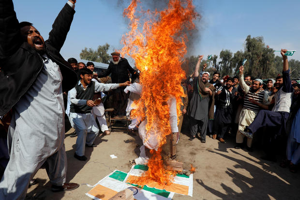 People chant slogans as they burn an effigy depicting Indian Prime Minister Narendra Modi, after Pakistan shot down two Indian military aircrafts, according to Pakistani officials, in Peshawar 