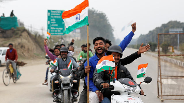 People ride motorbikes before the arrival of Indian Air Force pilot, who was captured by Pakistan on Wednesday, near Wagah border, on the outskirts of the northern city of Amritsar 