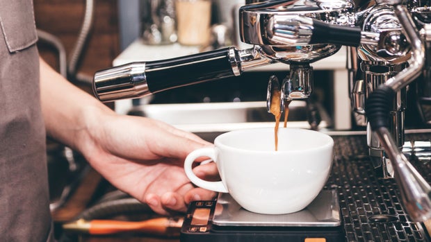 Women Barista using coffee machine