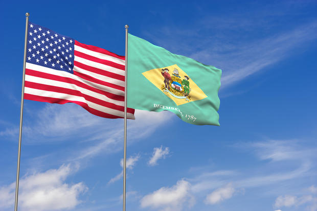 USA and Delaware flags over blue sky background. 3D illustration 