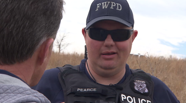 Fort Worth Officer Matt Pearce talks to Doug Dunbar in the spot where Pearce was shot six times. 