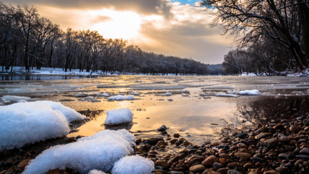 Snow and ice float down the Grand River in Grand Rapids 