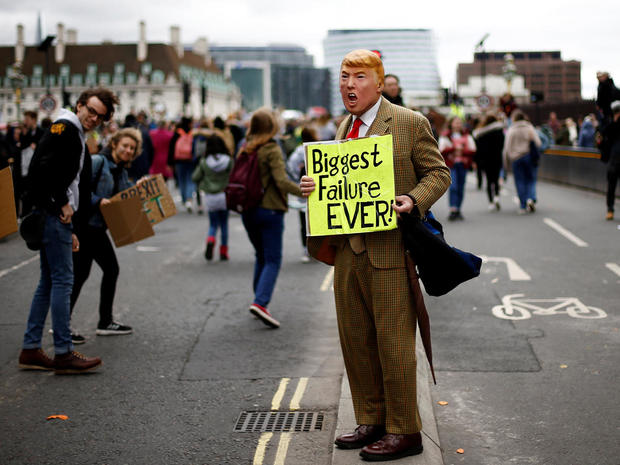 A demonstrator, wearing a mask depicting U.S. President Donald Trump, takes part in a protest against climate change, organised by the YouthStrike4Climate movement, in London 