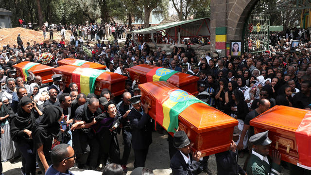 Pallbearers carry the coffins of the victims of the Ethiopian Airline Flight ET 302 plane crash, during the burial ceremony at the Holy Trinity Cathedral Orthodox church in Addis Ababa 