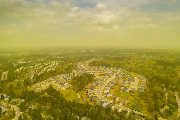 An aerial view shows pollen haze tinting the environment yellow over an area in Durham, North Carolina 
