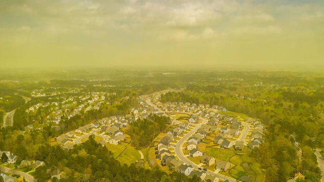 An aerial view shows pollen haze tinting the environment yellow over an area in Durham, North Carolina 