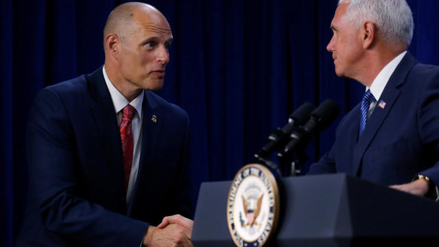 Acting director of the Immigration and Customs Enforcement agency (ICE) Ronald Vitiello (L) shakes hands with U.S. Vice President Mike Pence before Pence delivered remarks at ICE headquarters in Washington, U.S. 