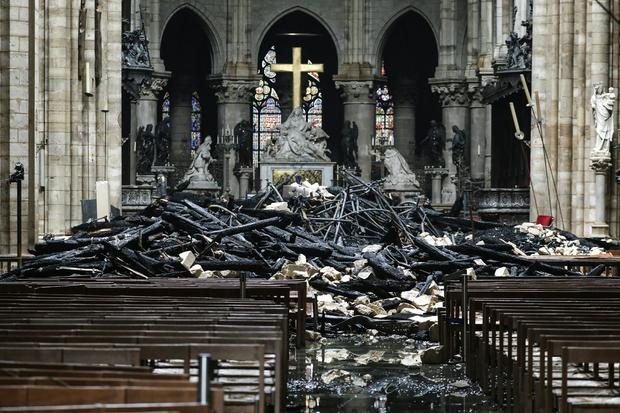 Charred debris surrounds the altar of Paris' Notre Dame Cathedral in the aftermath of a massive fire April 16, 2019. 