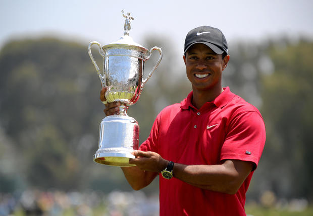 Tiger Woods of the US holds his trophy a 