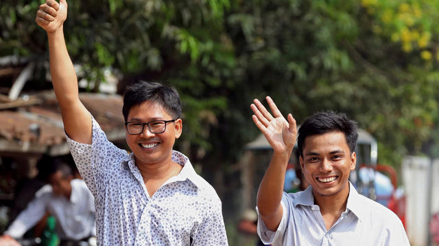 Reuters reporters Wa Lone and Kyaw Soe Oo gesture as they walk to Insein prison gate after being freed, after receiving a presidential pardon in Yangon 