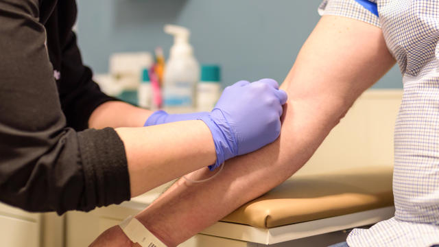 Man getting blood drawn at routine health screening 