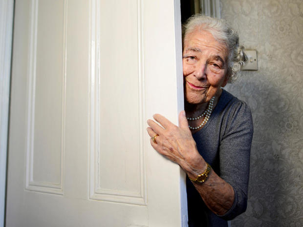 FILE PHOTO: British children's writer and illustrator Judith Kerr peers around a door as she recreates a scene from her bestselling picture book "The Tiger Who Came To Tea" , in London 