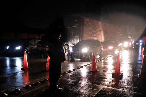 Policemen make traffic stop following an earthquake on a highway in San Salvador 