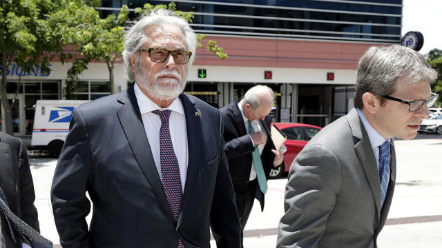 Carnival Corp. Chairman Micky Arison, left, arrives at federal court June 3, 2019, in Miami. 