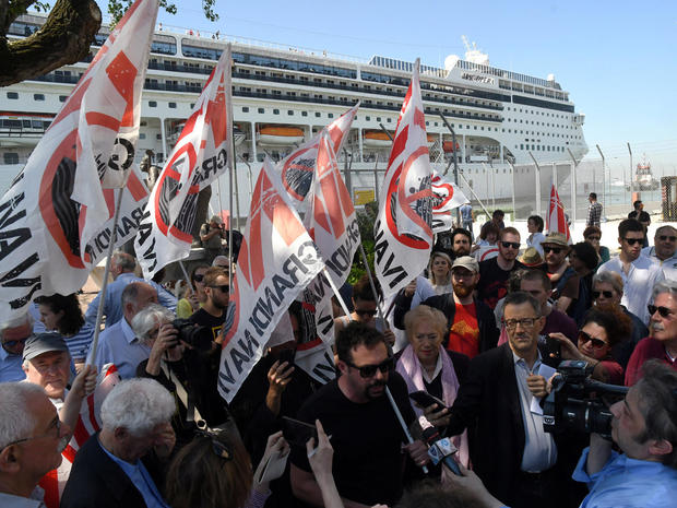 Members of "No grandi navi - No big ships" movement protest in front of the MSC Opera cruise ship that early in the morning crashed against a smaller tourist boat at the San Basilio dock in Venice 