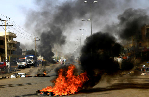 Sudanese protesters use burning tyres to erect a barricade on a street, demanding that the country's Transitional Military Council hand over power to civilians, in Khartoum 