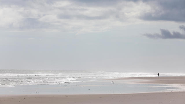 A person can be seen in the distance at the beach on Topsail Island, North Carolina, on Sept. 12, 2018, in advance of Hurricane Florence. 