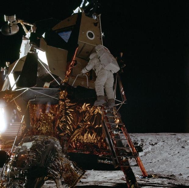 Apollo 12 Mission image - Dark view of Astronaut Alan L. Bean climbing down the ladder of the Lunar Module (LM) 