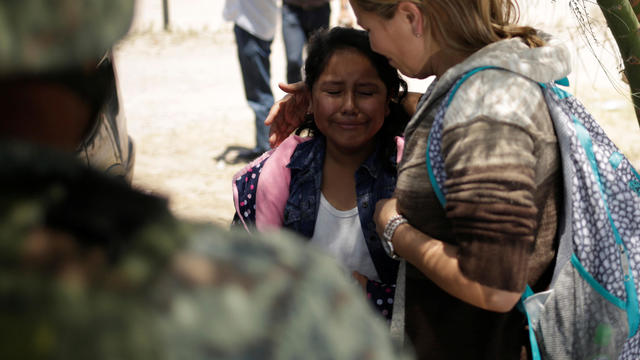 A young girl from Nicaragua is comforted by her mother after they were detained by members of Mexico's National Guard while trying to cross illegally the border between the U.S. and Mexico, in Ciudad Juarez 