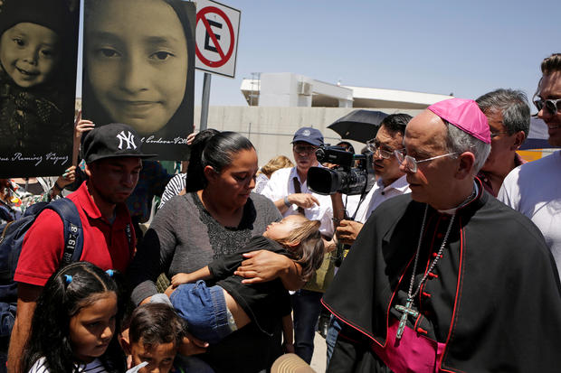 El Paso Bishop Mark Seitz chats with Honduran migrants who were deported after crossing the Paso del Norte international border crossing bridge from El Paso, Texas, U.S., in Ciudad Juarez 
