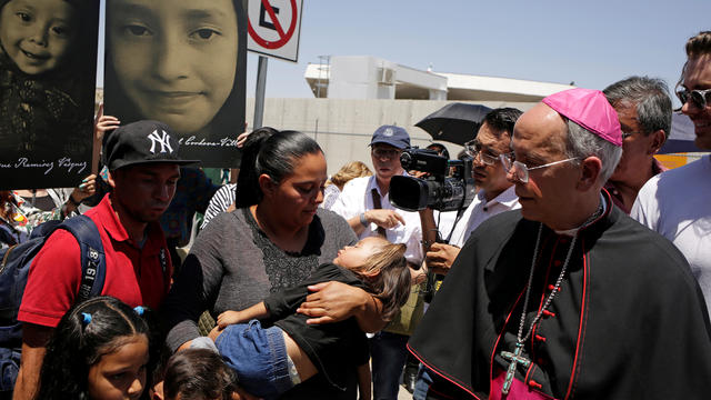 El Paso Bishop Mark Seitz chats with Honduran migrants who were deported after crossing the Paso del Norte international border crossing bridge from El Paso, Texas, U.S., in Ciudad Juarez 