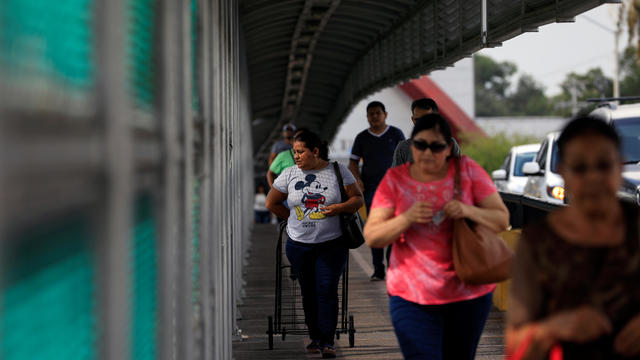 People cross the the Brownsville-Matamoros International Bridge on the U.S.-Mexico border in Matamoros, Tamaulipas 
