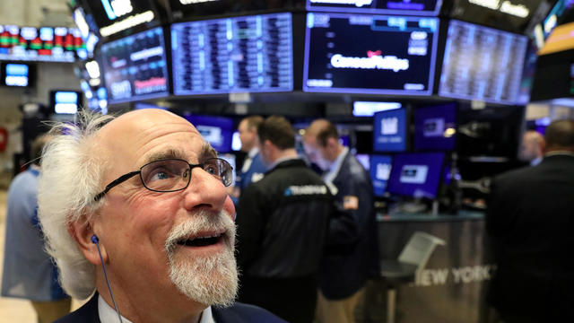 FILE PHOTO: Traders work on the floor at the NYSE in New York 