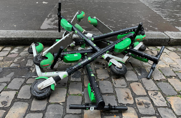 Dock-free electric scooters Lime-S by California-based bicycle sharing service Lime are stacked on Parisian cobblestones in a street of Paris 