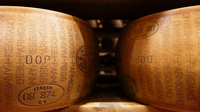 FILE PHOTO: A storage area for Parmesan cheese wheels is pictured at storehouse shelf at 4 Madonne Caseificio dell'Emilia dairy cooperative in Modena 