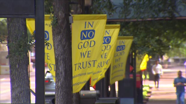 In No God We Trust banners in downtown Fort Worth