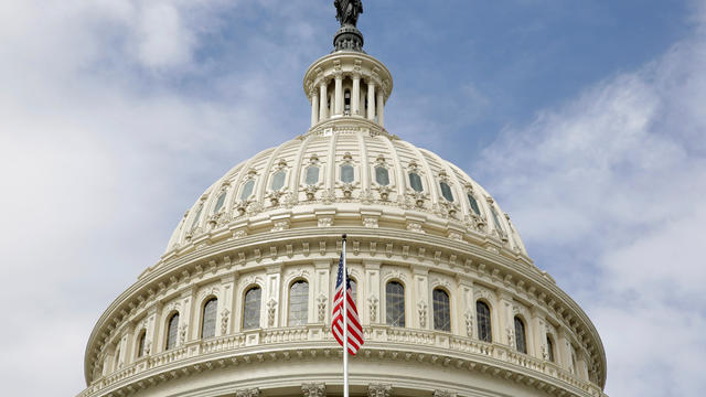 The U.S. flag flies in front of the dome of the U.S. Capitol in Washington Sept. 12, 2017. 